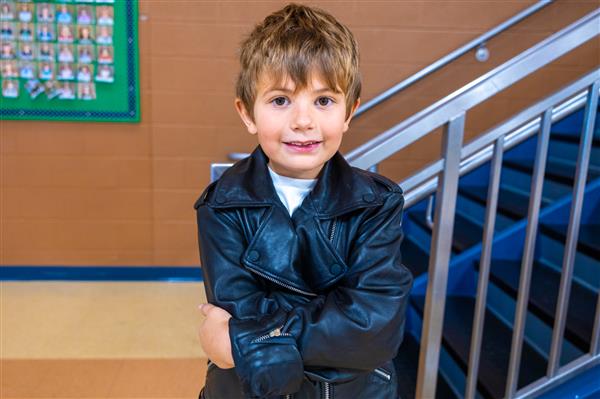 boy with his arms crossed in a leather jacket